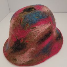 This Adorable Felted Wool hat is made from 100%  high quality  imported wool from New Zealand. It is handmade with wool, warm water and soap.  This hat can be used in Fall and Winter . It is  soft and cozy! It's a practical item to make your fall and winter outfit stand out. It can be easily matched with any style. Comfortable fit. Foldable, crushable & easy to pack.  It can be a great gift for you Loved one. One size to fit average woman's head. The diameter of the hat is 7 inches.  CARE: Hand Warm Adjustable Wool Hat, Multicolor Wool Hat For Fall, Wool Brimmed Felt Hat, Winter Wool Mini Hats With Short Brim, Wool Felt Hat With Curved Brim, Winter Wool Mini Hat With Curved Brim, Winter Fedora Hat One Size, Brimmed Felt Hats One Size, Adjustable Wool Felt Hat Handmade