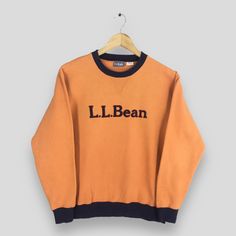 Vintage LL Bean Usa Orange Sweatshirt Small LL Bean Spell Out Crewneck Ll Bean Sportswear Embroidery Pullover LL Bean Jumper Sweater Size S Size On Tag :- Size Kid XL fits like Size S Manual Measurement :- WIDTH (armpit to armpit) :- 21" inches LENGTH (shoulder to end of garment) :- 24" inches WEIGH :- 0.40 kg Condition :- Good Condition. Has pinholes at sleeve, please refer a picture. - Colors Might Be Different Due To Lighting. - All items are VINTAGE which show some signs of wear and tear. FE Sporty Crew Neck Sweater With Embroidered Logo, Sportswear Crew Neck Top With Embroidered Logo, Sportswear Tops With Embroidered Logo And Crew Neck, Sportswear Tops With Embroidered Logo, Crew Neck, Collegiate Orange Crew Neck Top, Orange Collegiate Crew Neck Top, Sportswear Sweatshirt With Embroidered Logo, Varsity Crew Neck Sweater With Embroidered Logo, Sportswear Sweatshirt With Embroidered Logo And Crew Neck