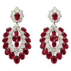 No gemstone represents a celebration more than a bright, red ruby and these amazing chandelier earrings have 36 of them. The 42 bright, white oval diamonds also hold their own at any festive event. The design of the earrings is classical and will never go out of style, and the strong contrasting colors create an unmistakably bold look. 36 Burmese rubies total weight app. 30 carats 42 diamonds total weight app. 11 carats The handmade platinum mounting was made in one of New York's finest ateliers Diamond Ornaments, Ruby Diamond Necklace, Red Jewellery, Diamond Chandelier Earrings, Diamond Chandelier, Burmese Ruby, Chandelier Modern, Platinum Earrings, Modern Bracelets