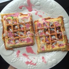 two waffles on a plate with sprinkles and pink icing