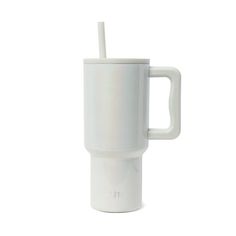 a white cup with a straw sticking out of it's side, on a white background