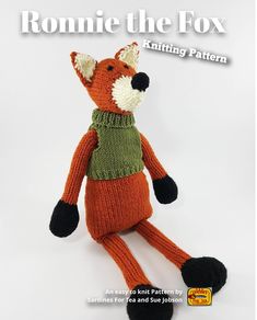 the knitted fox is wearing a green sweater