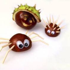 three chocolate candies with googly eyes and spiky sticks sticking out of them