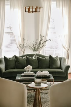 a living room with two couches and a coffee table in front of a window