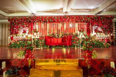 a red couch sitting on top of a set of steps in front of a stage