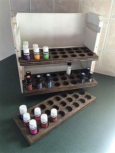 two wooden shelves with bottles on them and one shelf filled with essential oils, the other is empty