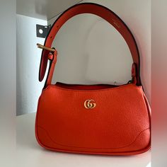 Gorgeous! Brand New! Comes With Box And Dustbag! Aphrodite Leather Shoulder Bag Aphrodite Leather Shoulder Bag From Gucci Featuring Orange Leather, Gold-Tone Logo Plaque, Top Zip Fastening, Adjustable Top Handle And Main Compartment Gucci Shoulder Bag With Branded Hardware, Trendy Gucci Shoulder Bag For Everyday Use, Trendy Gucci Shoulder Bag With Detachable Strap, Trendy Gucci Evening Bags, Bags Gucci, Orange Leather, Gucci Bags, Aphrodite, Gucci Bag