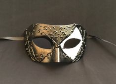 This men's Venetian masquerade mask has raised detail and is hand painted black and white. Mask is lightweight, durable, and has a comfortable fit. Comes with silk black ribbon ties attached. Mask is great for any Masquerade mask party! Adjustable Black Masquerade Mask For Carnival, Black Adjustable Masquerade Mask For Carnival, Black Adjustable Masquerade Mask, Elegant Black Masks And Prosthetics For Theater, Adjustable Black Masks And Prosthetics For Carnival, Black Formal Eye Mask Masquerade, Black Venetian Mask For Carnival, Black Formal Masquerade Mask For Halloween, Adjustable Black Eye Mask For Masquerade