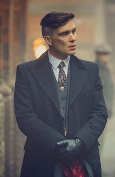 a man in a suit and tie standing on the street