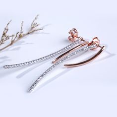 Sweet and sparkling, these dazzling earrings create a perfect look for everyday style or special moments. A curved ribbon of rose gold color add femininity to this design, while sparking round stones add extra shimmer. A romantic gift, these sparkling earrings are a sweet treat.Carat Weight: 0.58 ctStone Size: 1.1 mmNumber of Stones: 58 Stone Shape: RoundStone Color: Diamond WhiteWeight: 3.4 gWidth: 2.07 mmHeight: 35.6 mmMaterial: 925 SilverPlating Color: Silver, Rose Gold Elegant Rose Gold Crystal Earrings With Cubic Zirconia, Rose Gold Diamond Crystal Earrings With Sparkling Stones, Rose Gold Diamond Crystal Earrings For Anniversary, Anniversary Rose Gold Diamond Crystal Earrings, Rose Gold Diamond Earrings For Party, Elegant Rose Gold Crystal Earrings With Sparkling Stones, Elegant Rose Gold Diamond Earrings With Sparkling Stones, Elegant Rose Gold Diamond Earrings For Party, Elegant Sparkling Rose Gold Earrings