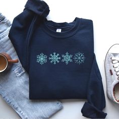 Personalized Christmas Embroidered Sweatshirt, Crewneck Tshirt Hoodie Snowflakes in Doodle Style For Winter, Christmas Gift, MADE IN USA There are two brands we use: Gildan and our own brand BeePro Handmade. Comfort Colors, Bella Canvas, and other brands are available upon request at a different price. If interested in adding embroidery to the sleeve please go to this listing: https://www.etsy.com/listing/1674502020 Because it is made to order, we don't accept the return or exchange unless we make a mistake We are unable to replace or refund purchases based on the color and the font selections. Please make sure to be very specific and make the correct selections when you place an order. Please feel free to reach out to us with any questions. We will do our best to make sure that you are co Winter Cotton Hoodie Gift, Winter Cotton Hoodie As Gift, Winter Hoodie In Cotton As Gift, Casual Embroidered Winter T-shirt, Winter Crew Neck Hoodie With Embroidered Graphics, Winter Fleece Tops With Embroidered Graphics, Winter Sweatshirt With Embroidered Graphics, Winter Gift Sweatshirt With Embroidered Graphics, Winter Sweatshirt With Embroidered Graphics As Gift