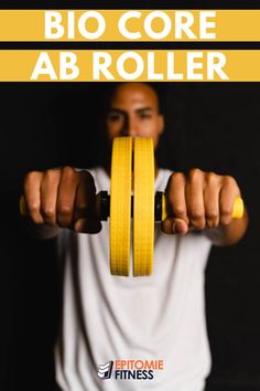 a man holding two yellow dumbs with the words bio core ab roller above him