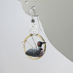 Feeling a little Loon-y? Then take a peek at these whimsical and wonderful Loon earrings that are artisan made, hand painted, and handcrafted in sterling silver, jeweler's brass and eclectica. They are a true pair, with each side facing the other (or away, depending on their mood) and measure just over 1.5 inches in length from the wire to the base and .75 inch wide. The Birds are in excellent, new condition and unmarked, although guaranteed to be the above mentioned material. A fun pair for a f Whimsical Hand Painted Silver Earrings, Whimsical Hand Painted Drop Earrings, Whimsical Hand Painted Dangle Jewelry, Whimsical Hand Painted Enamel Jewelry, Whimsical Hand Painted Earrings For Gifts, Duck Earrings, Peacock Ring, Spring Birds, Shorebirds