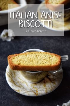 there is a piece of bread on top of a saucer with the words italian anise biscotti above it