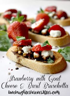 strawberries with goat cheese and basil bruscheta on toasted bread topped with fresh spinach leaves