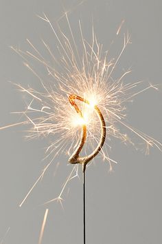 a sparkler that has been placed on top of a stick with some kind of thing in it