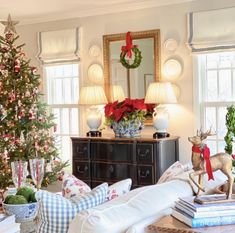 a living room filled with furniture and a christmas tree