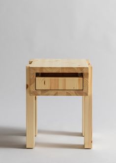 a small wooden table sitting on top of a white floor