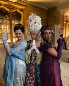 three women dressed in costume posing for the camera