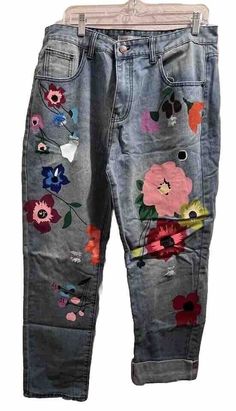 Add a unique touch to your wardrobe with these Misslook women's jeans in size 2XL. These jeans feature a painted floral design, making them perfect for a bohemian or hippie-themed outfit. The high-rise waist and straight leg fit provide comfort, while the slash pockets offer practicality. The button and zipper closure adds accents to the denim fabric, which is a cotton blend. These jeans are machine washable and suitable for medium fabric wash. Ideal for winter, summer, fall, and spring, these Misslook jeans are a must-have for any fashion-forward woman. Floral Painted Jeans, Mid-rise Floral Print Jeans For Summer, Colorful Flower Jeans, Casual Mid-rise Jeans With Floral Embroidery, Floral Embroidered Jeans With Multicolor Detail, Summer Mid-rise Floral Embroidered Jeans, Flower Jeans, Hippie Festival, Painted Jeans