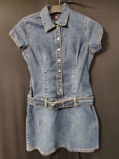 First, sizing has changed over the years. This dress fits more like a modern size 8 even though it says 11/12.  Amazing condition with snap closures. Metal belt buckle and nice thick denim/jean material.  Definitely 1990s-Y2K style. Made in Hong Kong so it is vintage.  CHECK OUT MY OTHER VINTAGE ITEMS AT: www.ginnyspenniessc.etsy.com This is a vintage or antique item. I do my best to describe each item as accurately as possible with full disclosure. However, with items of this age you should exp Fitted Medium Wash Belted Denim Dress, Y2k Fitted Denim Dress, Y2k Style Fitted Denim Dress, Retro Fitted Denim Dress With Pockets, Fitted Vintage Denim Dress With Pockets, Jean Mini Dress, Jean Material, Full Disclosure, Metal Belt