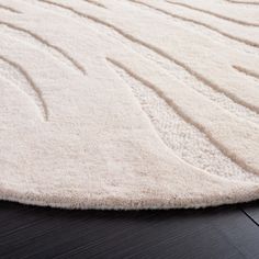 a white rug with wavy lines on it