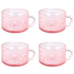 four pink glass mugs sitting next to each other