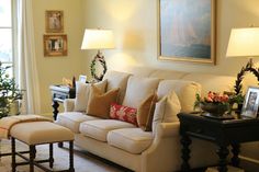 a living room filled with furniture next to a christmas tree in front of a window