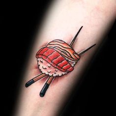 a tattoo with chopsticks and a piece of sushi on it's arm