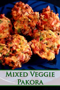 mixed veggie pakoras on a blue plate with the title above it