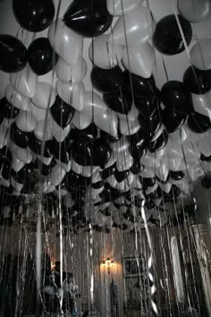 black and white balloons hanging from the ceiling