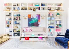 a living room filled with furniture and lots of bookshelves on top of it