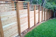 a wooden fence in the middle of a yard