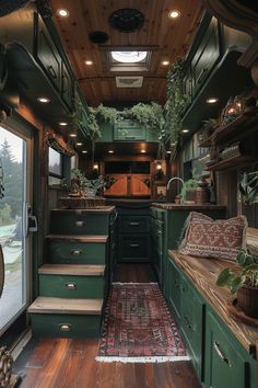 an interior view of a green camper with stairs leading up to the kitchen area