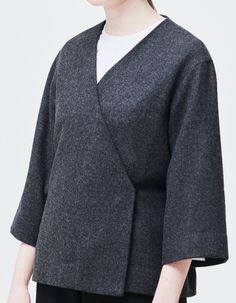 This oversized wrap blouse, made from soft to the touch medium weight wool, is a must have for the practical lady who wants one top that does it all. The piece allows to be worn as a blouse or a light coat on cooler days, it is fastened with buttons on the side, and it has an optional belt to define the silhouette and adjust the blouse your way. Additionally, the V-neck and the ¾ wide sleeves, make the Stella blouse perfect for accessorizing.Item: Handmade and made to orderMaterial: 100% medium- Winter Wrap Tops For Workwear, Fall Layering Wrap Top, Oversized Wool Tops For Layering, Oversized Shawl Collar Cardigan For Work, Modern Wool Tops For Fall, Chic Wrap Top For Winter, Versatile Oversized Blouse For Fall, Chic Oversized Wrap Outerwear, Oversized Chic Wrap Outerwear