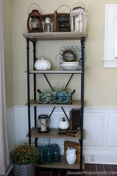 a shelf filled with lots of pots and pans on top of it's shelves