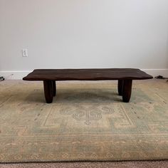 a wooden table sitting on top of a rug