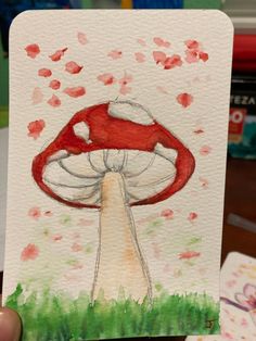 a drawing of a red mushroom in the grass