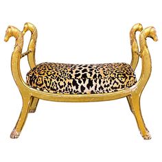 a gold bench with leopard print upholstered on it