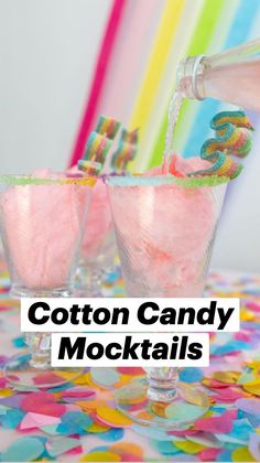 two glasses filled with pink liquid on top of a colorful table cloth covered in confetti