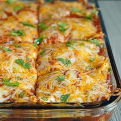 a casserole dish with cheese, meat and vegetables in it on a wooden table