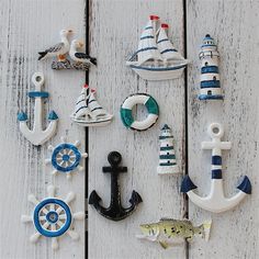 an assortment of sea themed ornaments on a white wooden surface