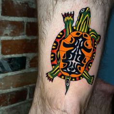 a colorful turtle tattoo on the leg