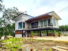 a large house sitting on top of a lush green field