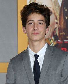 a young man wearing a suit and tie