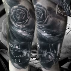 a black and white photo of a man's leg with a rose on it