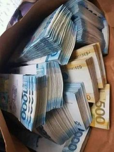 a box filled with lots of money sitting on top of a table