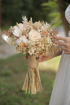 a bride holding a bouquet of flowers in her hands