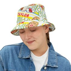 Recommended deadline for delivery by Christmas - Dec. 6 "Go Swifties!" 🏈 Featuring my original illustration of Taylor Swift in the style of Kansas Chief's logo & colors. Introducing our all-over print bucket hat, a great accessory to complete any outfit, while keeping you cool & shaded from the sun. - Available in 2 sizes- 100% Polyester- Made in the USA- Ships out in 3-5 business days Tap here to see all of my items featuring Taylor Swift! Thanks for shopping with us! Summer Cotton Hats With Logo Print, Summer Cotton Hat With Logo Print, Fun Adjustable Graphic Print Hat, Trendy Adjustable Hats With Logo Print, Fun Adjustable Hat With Graphic Print, Casual Adjustable Hat With Graphic Print, Casual Curved Brim Hat With Graphic Print, Casual Summer Hats With Logo Print, Adjustable Cotton Hats With Graphic Print