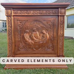 carved wooden plaque with the image of jesus and his family on it in front of a house